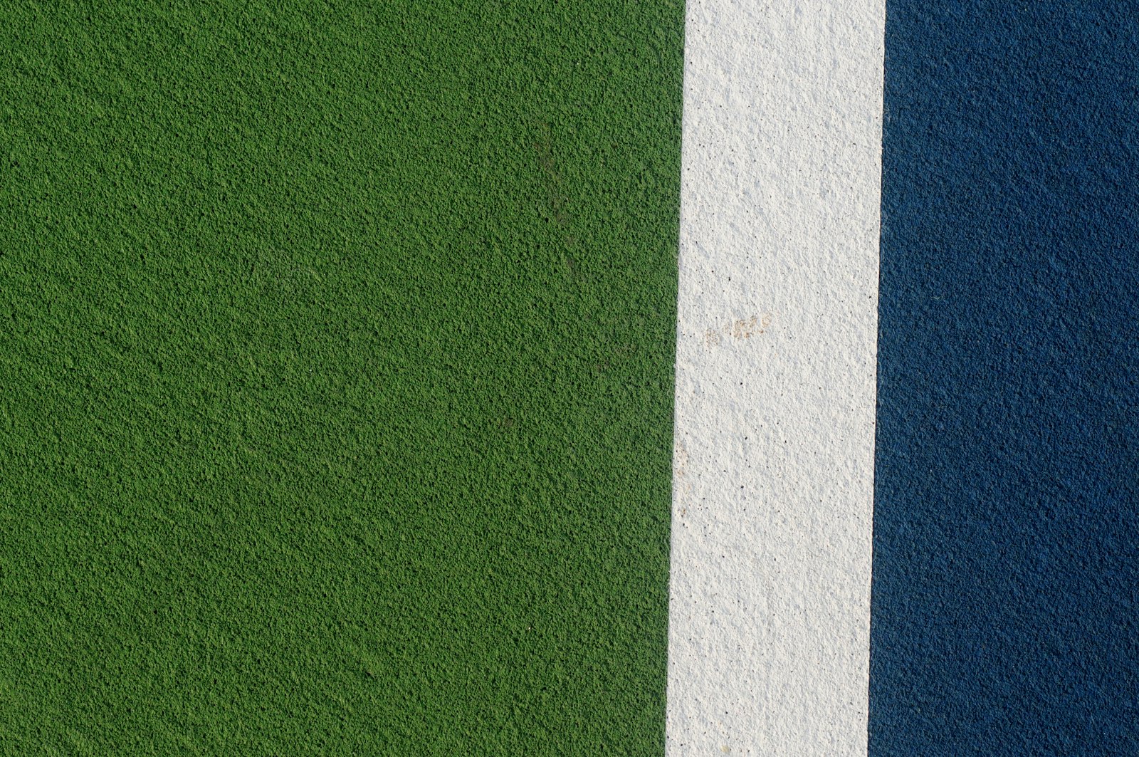 Close-up of freshly installed athletic surfacing material